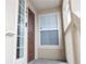 Exterior entrance with a brown front door, a window, and a view of the porch at 10035 E Carolina Pl # 201, Aurora, CO 80247