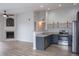 Modern kitchen features stainless steel appliances, open shelving, and ample counter space at 10035 E Carolina Pl # 201, Aurora, CO 80247