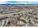 Expansive aerial view of a residential area nestled against a backdrop of snow-capped mountains at 3228 47Th, Boulder, CO 80301