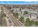 Expansive aerial view of townhomes, a nearby road, and green trees, capturing location and community at 3228 47Th, Boulder, CO 80301