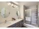 Bathroom featuring double sinks, modern lighting, a glass shower with tiled walls and a sliding door at 3228 47Th, Boulder, CO 80301