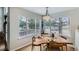 Sunlit dining area featuring a unique wood table, chandelier, and a view of the outdoors at 3228 47Th, Boulder, CO 80301