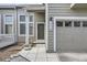 Inviting entrance to a home with a gray exterior, a small porch, and an attached one-car garage at 3228 47Th, Boulder, CO 80301
