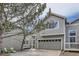 Inviting two-story townhome with a gray-beige exterior, an attached garage, and a landscaped yard at 3228 47Th, Boulder, CO 80301