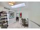 Bright hallway features a skylight and artwork, leading to an office space at 3228 47Th, Boulder, CO 80301