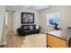 Cozy living room features hardwood floors, a comfortable couch, and an abundance of natural light from the window at 3228 47Th, Boulder, CO 80301