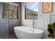 Relaxing bathroom featuring a freestanding soaking tub and natural light at 5370 Pine Ridge Rd, Golden, CO 80403