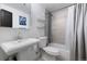 Clean bathroom with white vanity, shower/tub combo, and gray tile at 5370 Pine Ridge Rd, Golden, CO 80403