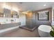 Luxurious bathroom with double sinks, soaking tub, and a walk-in shower at 5370 Pine Ridge Rd, Golden, CO 80403