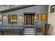 Modern front entrance with sleek black door and a welcoming deck at 5370 Pine Ridge Rd, Golden, CO 80403