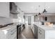 Modern kitchen with white cabinets, stainless steel appliances, and island at 5370 Pine Ridge Rd, Golden, CO 80403