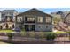 A home's backyard with a patio, staircase and landscaped terrace at 7965 S Vandriver Way, Aurora, CO 80016