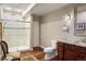 Bathroom features a glass-enclosed shower with rainfall shower head, dark cabinets, and granite vanity at 7965 S Vandriver Way, Aurora, CO 80016