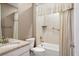 Bathroom featuring a shower with white tile and a white vanity with a granite countertop at 7965 S Vandriver Way, Aurora, CO 80016