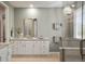 Spa like bathroom boasts large vanity, granite countertops, walk-in glass shower and neutral paint at 7965 S Vandriver Way, Aurora, CO 80016