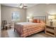 Bedroom with tray ceiling features neutral walls, carpet, and double window for natural light at 7965 S Vandriver Way, Aurora, CO 80016