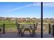 Outdoor deck features seating overlooking a golf course and other residential homes in the community at 7965 S Vandriver Way, Aurora, CO 80016