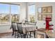 Sunny dining room featuring large windows, black dining set, and red stand mixer at 7965 S Vandriver Way, Aurora, CO 80016