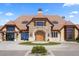 A luxurious home showcasing stone accents and a circular driveway at 7965 S Vandriver Way, Aurora, CO 80016