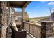 Front porch with a stone base, wood railing, and seating offers a cozy outdoor space at 7965 S Vandriver Way, Aurora, CO 80016