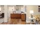 Spacious home office featuring a large desk, hardwood floors, and natural light at 7965 S Vandriver Way, Aurora, CO 80016