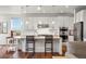 Bright kitchen features granite countertops, stainless steel appliances, island, and hardwood floors at 7965 S Vandriver Way, Aurora, CO 80016