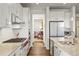 Well-equipped kitchen with modern appliances and a view into the dining room at 7965 S Vandriver Way, Aurora, CO 80016