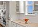 Kitchen with stone countertops, stainless steel appliances, white cabinetry and fruit bowl at 7965 S Vandriver Way, Aurora, CO 80016