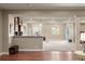 Open concept living room with hardwood floors, partial kitchen view, and ample space at 7965 S Vandriver Way, Aurora, CO 80016