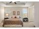 Comfortable bedroom features tray ceiling, windows, and neutral decor at 7965 S Vandriver Way, Aurora, CO 80016