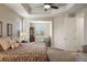 Spacious main bedroom features a tray ceiling, sitting area, and neutral decor at 7965 S Vandriver Way, Aurora, CO 80016