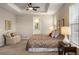 Main bedroom features a tray ceiling, sitting area, and ensuite bathroom at 7965 S Vandriver Way, Aurora, CO 80016