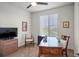 Home office with ceiling fan, large window, wood desk and furniture at 7965 S Vandriver Way, Aurora, CO 80016