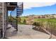 Outdoor patio with stone flooring and a spiral staircase overlooks a lush golf course and green space at 7965 S Vandriver Way, Aurora, CO 80016