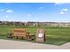 A putting range with bench seating provides a great place to practice golf at 7965 S Vandriver Way, Aurora, CO 80016