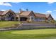 A golf-course home's rear elevation features stone accents and scenic views at 7965 S Vandriver Way, Aurora, CO 80016