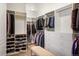 Spacious walk-in closet with custom shelving, hanging rods, drawers, and a bench at 7965 S Vandriver Way, Aurora, CO 80016