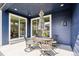 Cozy outdoor patio area with dining set under a patio umbrella, accessible via sliding glass doors at 8888 Falcon St, Longmont, CO 80504