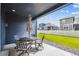 Outdoor patio space with patio table and chairs overlooking a lush lawn and fenced yard at 8888 Falcon St, Longmont, CO 80504
