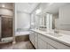 Bathroom with double sinks, white cabinets, separate shower and bathtub at 8888 Falcon St, Longmont, CO 80504