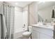 Clean bathroom with white tiled shower, modern vanity, and updated fixtures creating a serene atmosphere at 8888 Falcon St, Longmont, CO 80504