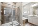 Well-lit bathroom featuring a glass-enclosed shower, soaking tub, and modern vanity at 8888 Falcon St, Longmont, CO 80504
