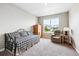 Cozy bedroom with a large window providing natural light and a comfortable seating area at 8888 Falcon St, Longmont, CO 80504