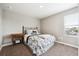 Cozy bedroom featuring a comfortable bed, a side table, and a window with bright, natural light at 8888 Falcon St, Longmont, CO 80504