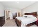 Spacious bedroom with a large bed and dark wood furniture at 8888 Falcon St, Longmont, CO 80504