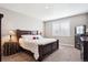 Cozy bedroom showcasing a plush bed, neutral tones, and a bright window at 8888 Falcon St, Longmont, CO 80504