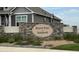 Stone community sign reads Falcon Point at Saddleback, surrounded by manicured landscaping, gives a sense of upscale living at 8888 Falcon St, Longmont, CO 80504