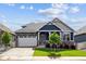 Charming blue two-story home with landscaped yard, stone accents, and a well manicured lawn at 8888 Falcon St, Longmont, CO 80504