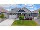 Beautiful home featuring a two-car garage, well-kept lawn, and charming architectural details enhances its curb appeal at 8888 Falcon St, Longmont, CO 80504