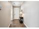 Bright foyer with hardwood floors, white trim, and modern light fixture at 8888 Falcon St, Longmont, CO 80504